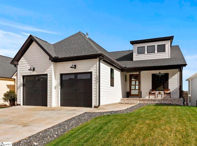 view of front of house with driveway, a porch, a shingled roof, a front lawn, and a garage