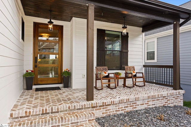 view of exterior entry with a porch