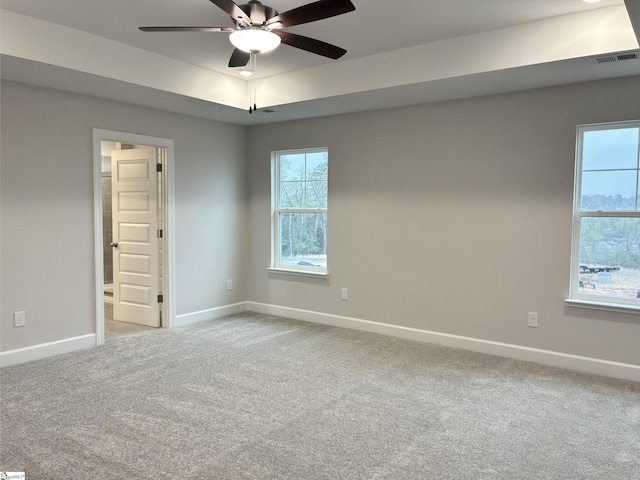 spare room featuring light carpet, baseboards, visible vents, and ceiling fan