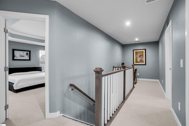 corridor featuring recessed lighting, baseboards, carpet flooring, and an upstairs landing