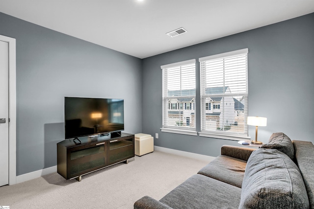 living room with carpet floors, visible vents, and baseboards