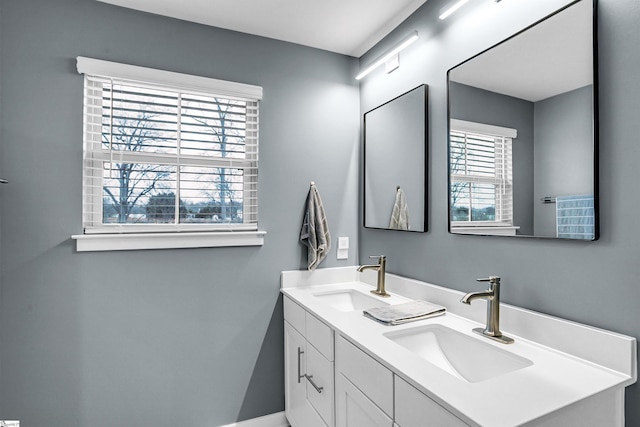 bathroom featuring a sink and double vanity