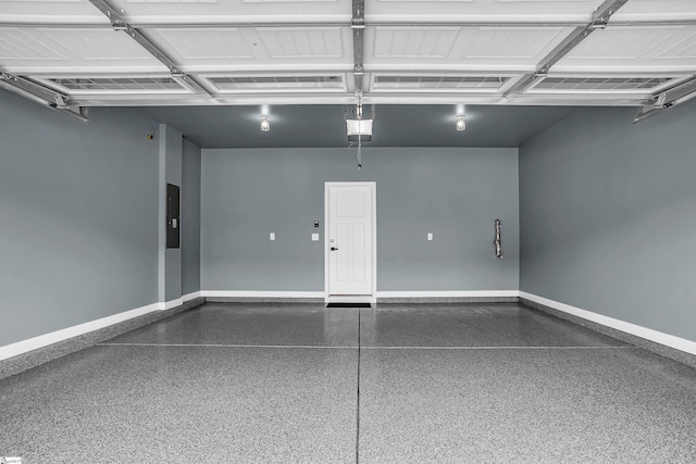 garage featuring a garage door opener, electric panel, and baseboards