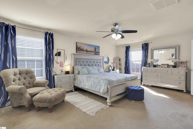 bedroom featuring ceiling fan, carpet flooring, and visible vents