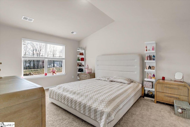 bedroom with visible vents, vaulted ceiling, and light carpet