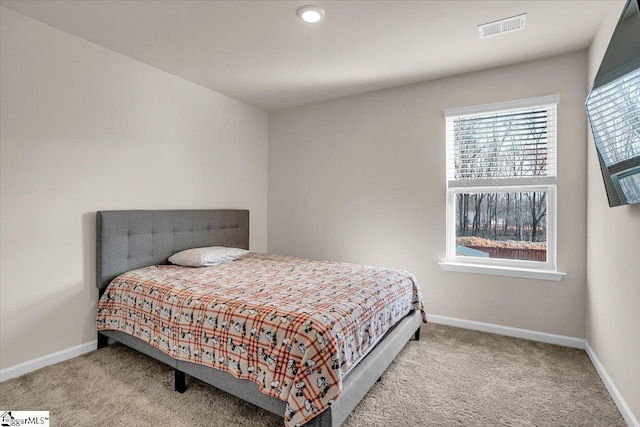 carpeted bedroom with visible vents and baseboards