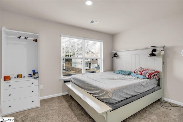 bedroom featuring baseboards, visible vents, and light colored carpet