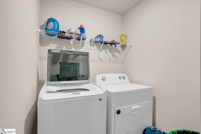 clothes washing area featuring laundry area and separate washer and dryer