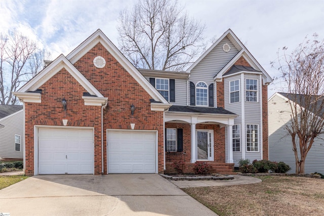 traditional-style home with brick siding, driveway, and a garage