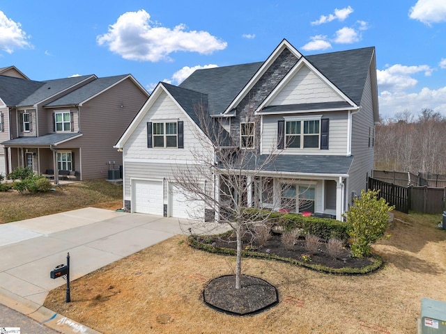 view of front of property featuring a porch, central AC unit, fence, a garage, and driveway