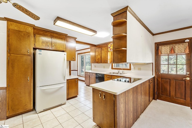 kitchen featuring a peninsula, open shelves, light countertops, black appliances, and brown cabinetry