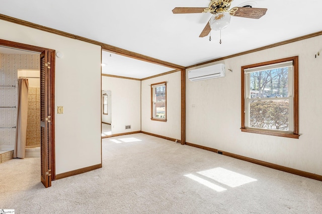 spare room with light colored carpet, a wall mounted air conditioner, crown molding, and baseboards