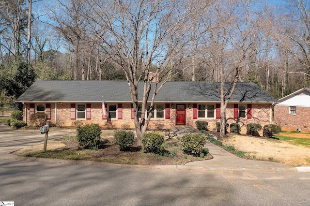 single story home featuring roof with shingles, brick siding, and crawl space