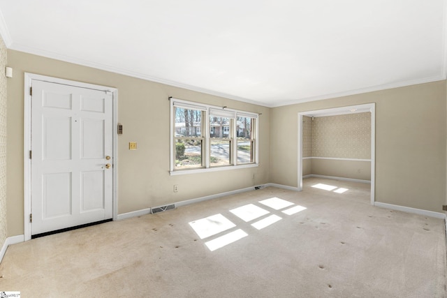 interior space featuring carpet floors, visible vents, ornamental molding, and baseboards