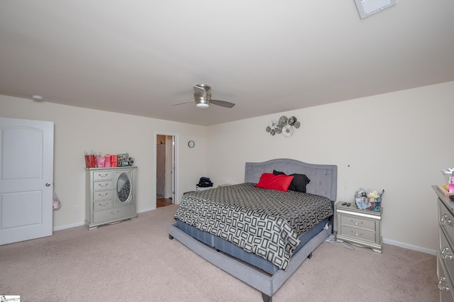 carpeted bedroom with ceiling fan, visible vents, and baseboards