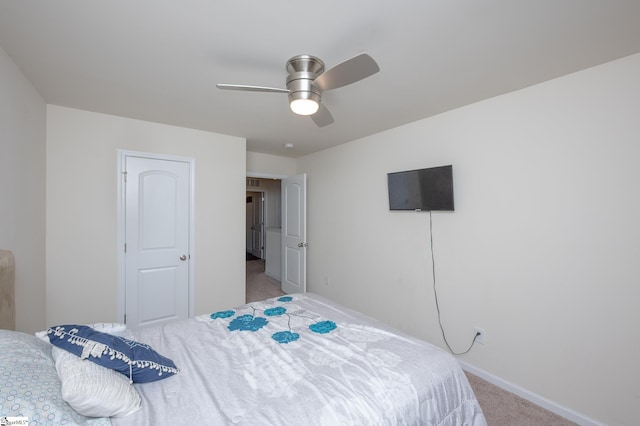 carpeted bedroom featuring ceiling fan and baseboards