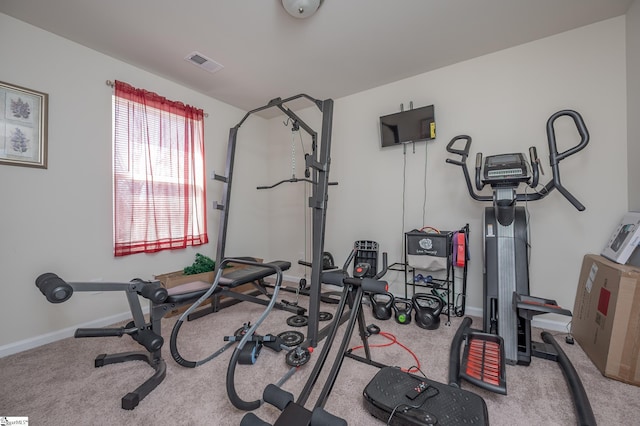 exercise room featuring carpet floors, baseboards, and visible vents