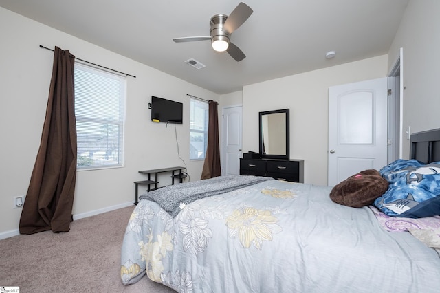 carpeted bedroom with baseboards, visible vents, and a ceiling fan