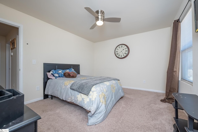 carpeted bedroom with ceiling fan and baseboards