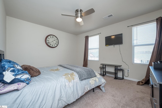 carpeted bedroom with baseboards, visible vents, and ceiling fan