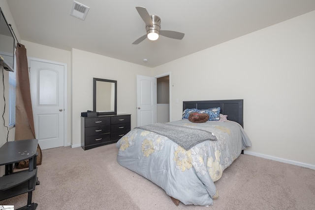 bedroom with light carpet, baseboards, visible vents, and a ceiling fan