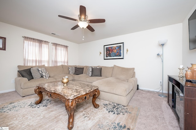 living area with carpet floors, visible vents, and baseboards