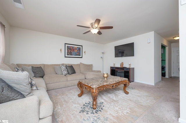 living room featuring visible vents, ceiling fan, and baseboards