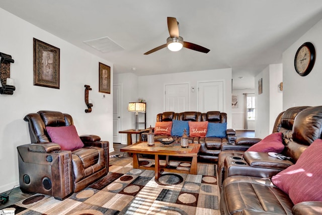 living room with ceiling fan, visible vents, and wood finished floors