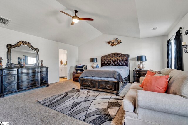 carpeted bedroom with vaulted ceiling, a ceiling fan, visible vents, and ensuite bathroom