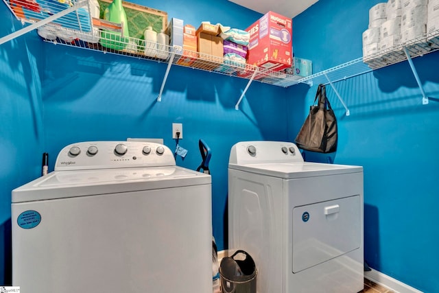 laundry area featuring laundry area, baseboards, and washing machine and clothes dryer