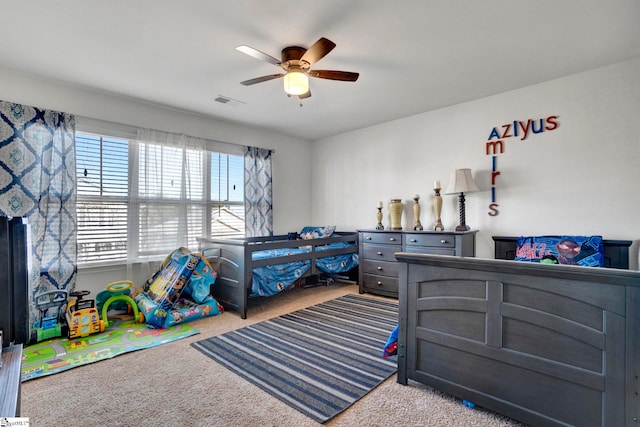 carpeted bedroom with ceiling fan and visible vents