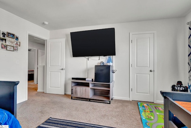 bedroom featuring carpet and baseboards