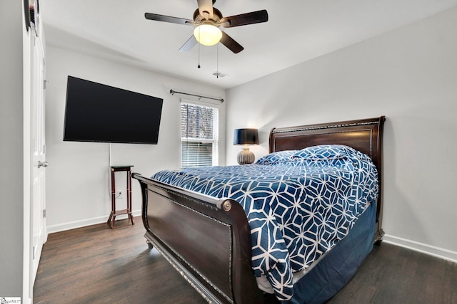 bedroom featuring a ceiling fan, visible vents, baseboards, and wood finished floors