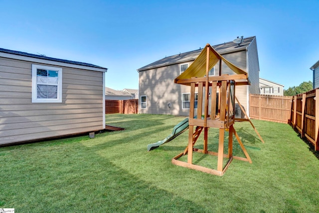 view of play area with a fenced backyard and a yard