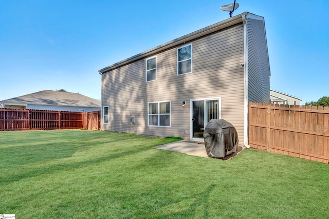 rear view of house featuring a fenced backyard, a yard, and a patio