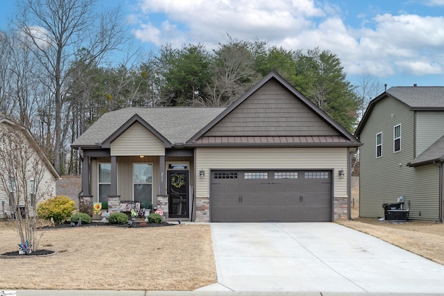 craftsman house with a garage, driveway, metal roof, a standing seam roof, and covered porch