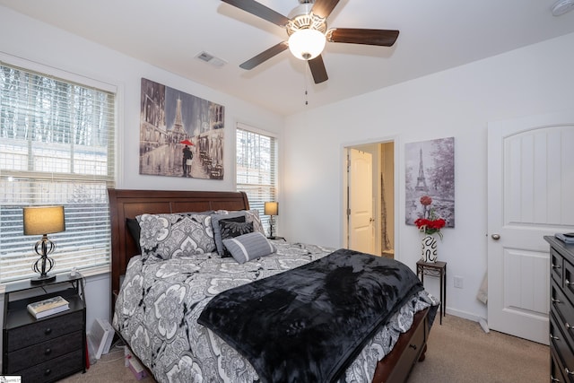 bedroom featuring light carpet, baseboards, visible vents, and ceiling fan