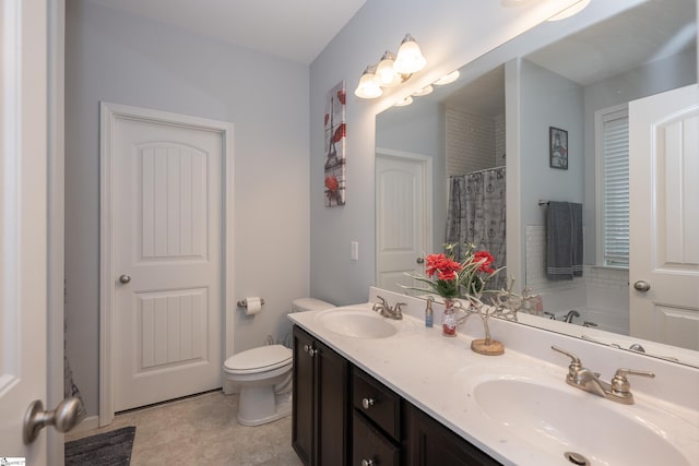 full bathroom featuring a sink, toilet, and double vanity