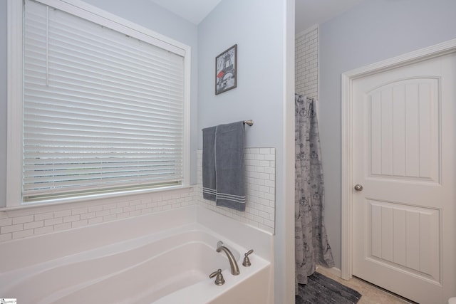 bathroom with a shower with curtain and a garden tub