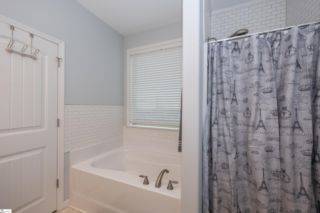 full bathroom with curtained shower and a garden tub