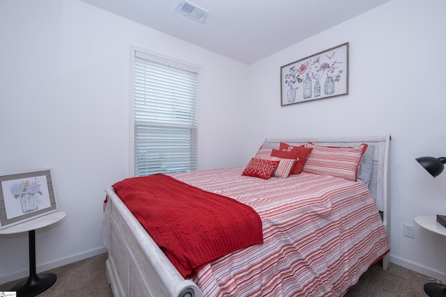 carpeted bedroom featuring visible vents and baseboards