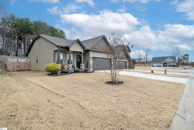 view of front of property with an attached garage, driveway, and a shingled roof