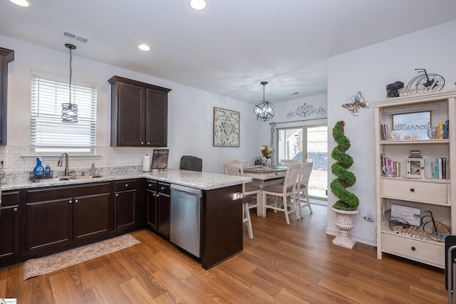 kitchen featuring visible vents, dishwasher, dark brown cabinets, light wood-type flooring, and a sink