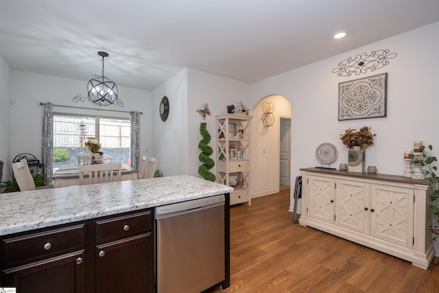 kitchen featuring arched walkways, dark brown cabinetry, wood finished floors, a chandelier, and dishwasher