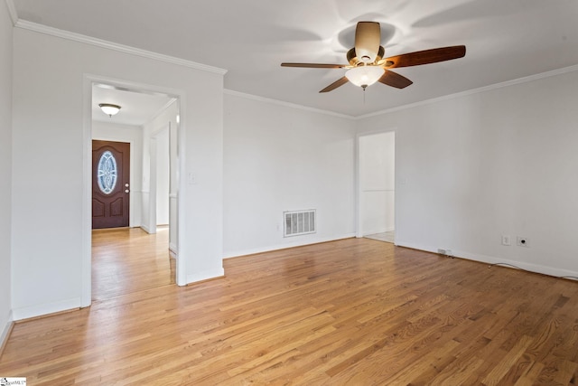 empty room featuring a ceiling fan, baseboards, visible vents, light wood-style floors, and crown molding