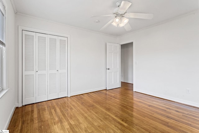 unfurnished bedroom with light wood finished floors, ornamental molding, a closet, and baseboards