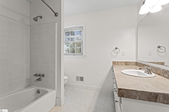 bathroom with visible vents, toilet, tub / shower combination, vanity, and tile patterned floors