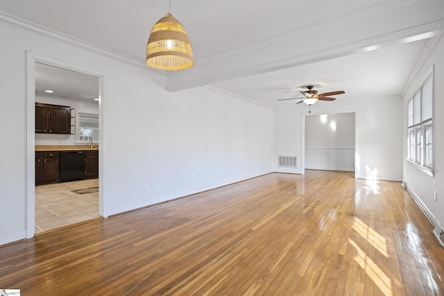 unfurnished room with light wood-type flooring, visible vents, crown molding, and ceiling fan with notable chandelier