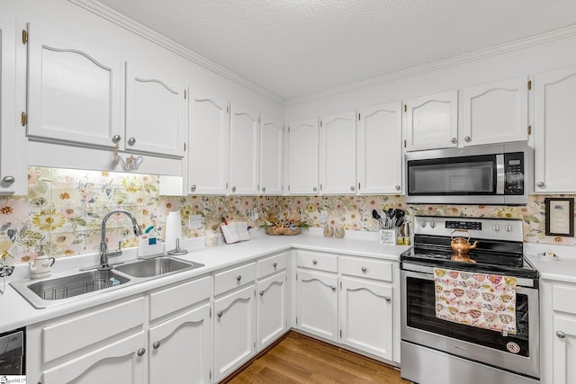 kitchen featuring light wood-style floors, white cabinetry, stainless steel appliances, and a sink