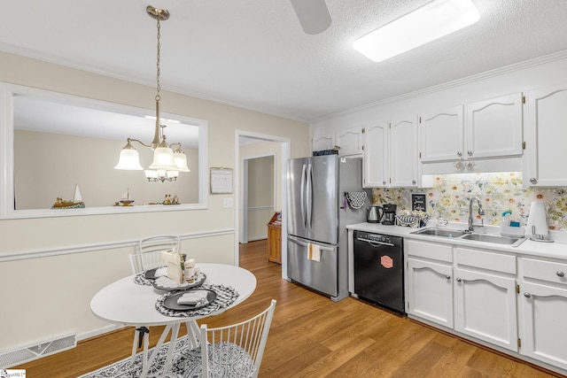 kitchen featuring visible vents, freestanding refrigerator, white cabinetry, a sink, and dishwasher